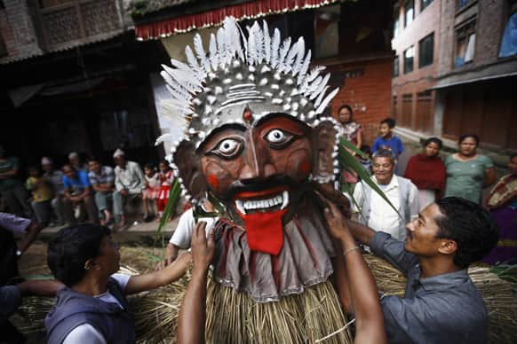 Nepalese people make an effigy of Ghanta Karna, symbolic of demons, during a festival celebrated after paddy planting in Bhaktapur, outskirts of Katmandu, Nepal.