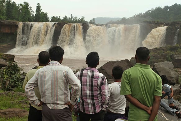 Tourists watch the Gira waterfalls which is in full flow following monsoon rains near Saputara in Dang district of Gujarat state, India. The Western state of Gujarat is currently holding the month long Saputara monsoon festival aimed at promoting tourism.
