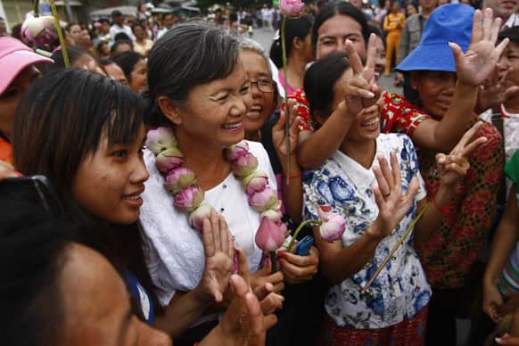 A Lawmaker of National Rescue Party Mu Sochua, center, poses for photographs with villagers during her visit to Boeung Kak lake, in Phnom Penh, Cambodia.