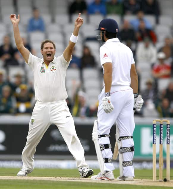 Australia`s Ryan Harris, celebrates the wicket of England`s captain Alastair Cook, right, during day five of the third Ashes Test match held at Old Trafford cricket ground in Manchester, England.