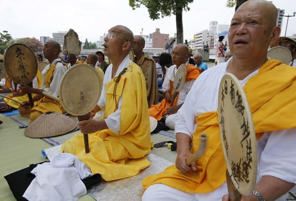 Buddhist monks chant a Buddhist mantra while beating drums in front of the Atomic Bomb Dome in Hiroshima, western Japan.