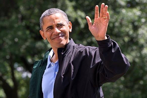 President Barack Obama waves to the media as he walks on the South Lawn of the White House in Washington after returning on Marine One from Camp David, Md., where he spent his birthday.