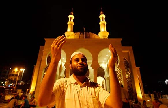 A Palestinian man prays during Laylat Al Qadr prayers on the 27th day of the holy fasting month of Ramadan outside the beach mosque in Gaza City.