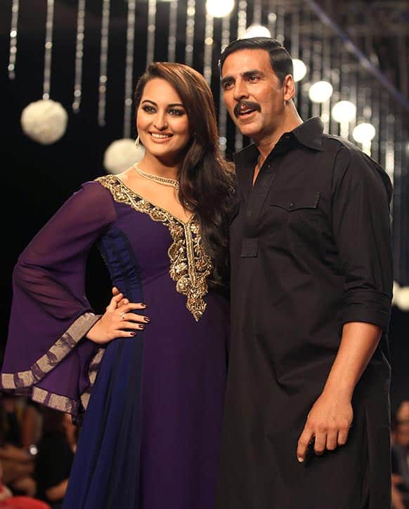Bollywood actors Sonakshi Sinha, left and Akshay Kumar pose after they walk the ramp on the first day of the India International Jewelry Week (IIJW) in Mumbai.