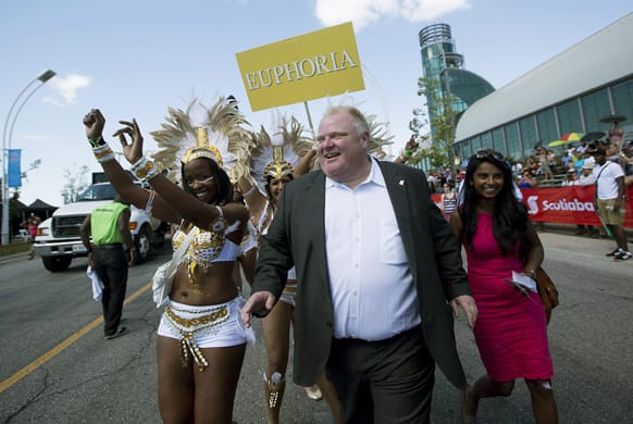 Toronto Mayor Rob Ford briefly dances with paraders at the The Scotiabank Toronto Caribbean Carnival in Toronto.