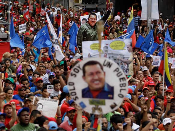 Posters and cutouts of the late Venezuelan leader Hugo Chavez dot the crowd as President Nicolas Maduro delivers a speech during a protest against corruption in Caracas, Venezuela.