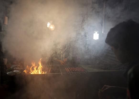 A Muslim vendor prepares kebabs for sale at the time of breaking fast during the Islamic holy month of Ramadan, in Bangalore.