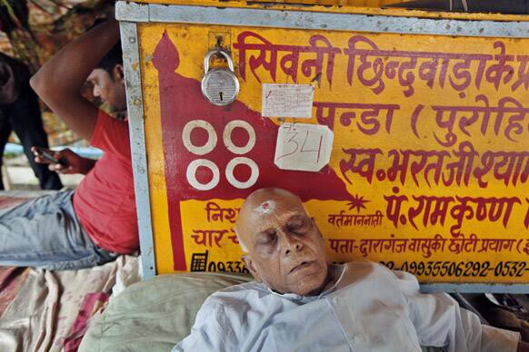 An Indian Panda, or Brahmin Hindu priest, rests at Sangam, the confluence of rivers, Ganges, Yamuna and the mythical Saraswati, in Allahabad.