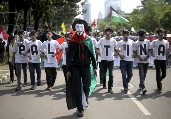 A Muslim protester wears Guy Fawkes mask during an anti-Israel protest marking the International Al-Quds Day outside the US Embassy in Jakarta.