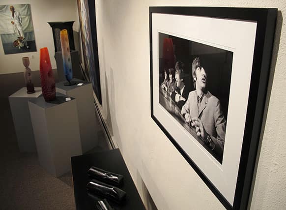 This image shows a photograph of the Beatles taken in 1964 by photographer Mike Mitchell on exhibit at the David Anthony Fine Art gallery in Taos, N.M.