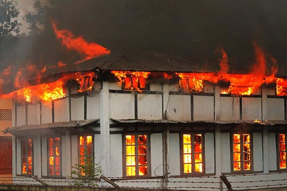 A government office building goes up in flames after protestors demanding the creation of a separate Karbi Anglong state set it on fire at Donkamukam, in Karbi Anglong district in northeastern Assam state, India.