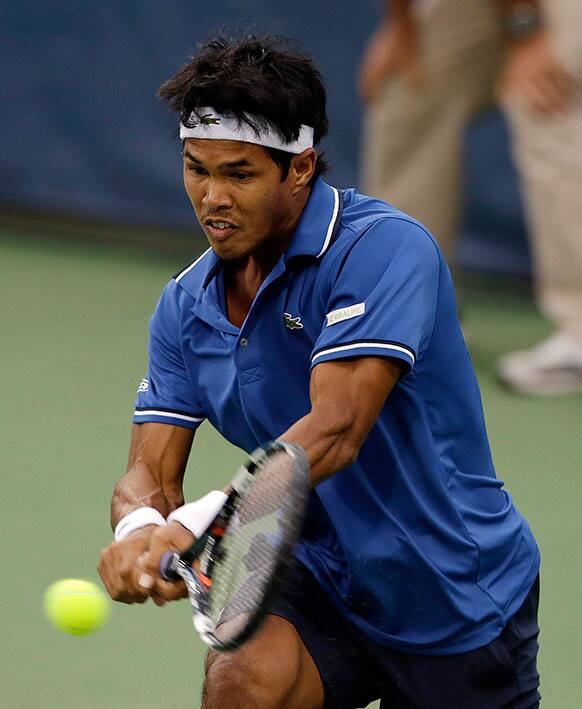 Somdev Dewarman, from India, return a ball during his match against John Isner at the Citi Open tennis tournament in Washington.