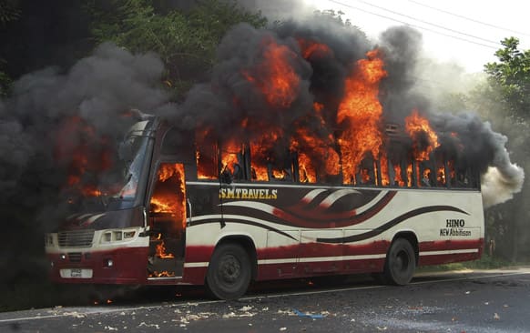 A bus goes up in flames after being set on fire by activists of Bangladesh’s Jamaat-e-Islami party after the Bangladesh high court disqualified the party from taking part in the next general election in Bogra, some 120 kilometers (75 miles) north of Dhaka.