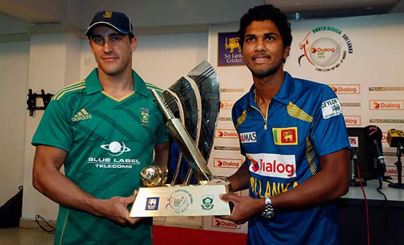 Sri Lanka`s captain Dinesh Chandimal, right, and his South African counterpart Faf du Plessis pose with the match trophy in Colombo, Sri Lanka.