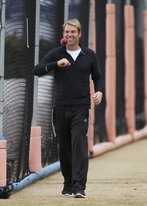 Australian former spin bowler Shane Warne smiles before bowling to the side`s captain Michael Clarke at a nets session the day before the start of the third Ashes series cricket match against England at Old Trafford cricket ground, Manchester, England.