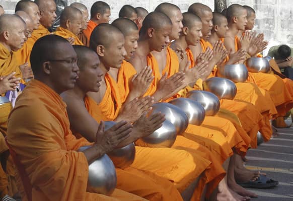 Buddhist monks pray during a morning alms offering ceremony held at the Muslim dominated province of Yala, southern Thailand.