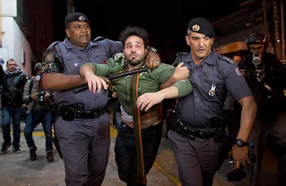 An anti-government demonstrator is detained by the police during a protest in Sao Paulo, Brazil.