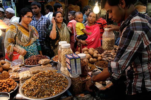 Muslim women buy dry fruits from a roadside vendor prior to breaking fast during Ramadan in Kolkata.