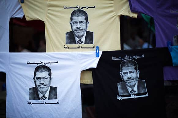 T-shirts with the face of Egypt`s ousted President Mohammed Morsi are displayed for sale at Nasr City, where protesters have installed a camp and hold daily rallies, in Cairo, Egypt.