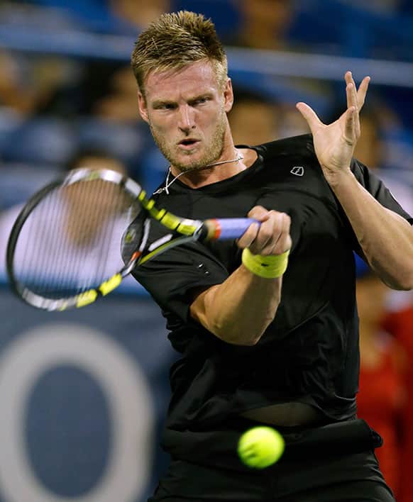 Samuel Groth, from Australia, hits a forehand to Milos Raonic, from Canada, at the Citi Open tennis tournament.