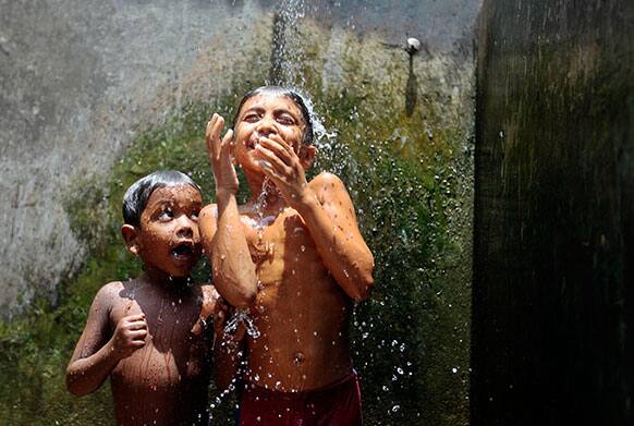 Bangladeshi children cool off at Mohammadpur Geneva camp in Dhaka. Mohammadpur Geneva Camp is one of the largest refugee camps in Dhaka City.