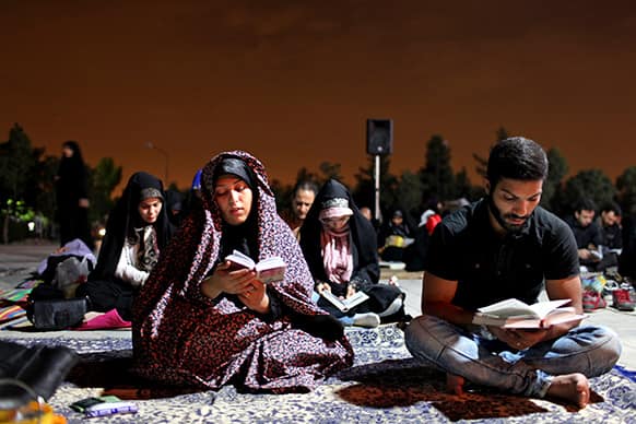 Iranians read Quran during a religious ceremony marking Imam Ali`s death at the Behesht-e-Zahra cemetery, just outside Tehran, Iran.