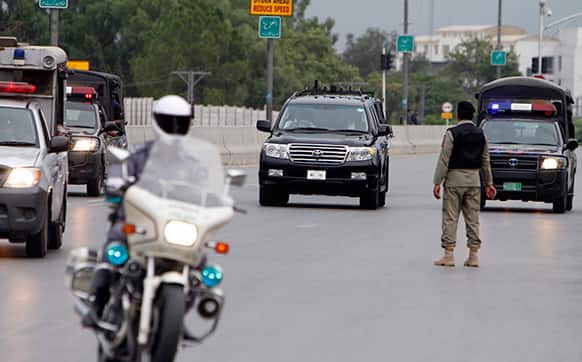 A convey of Pakistani security officials escort a vehicle, center, carrying Pakistan`s former President and military ruler Pervez Musharraf to an anti-terrorism court in Rawalpindi, Pakistan.