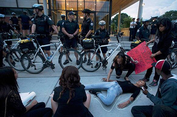 A protester is traced in chalk at Toronto Police 14 division as a vigil for Sammy Yatim, 18, turns into a protest in Toronto.