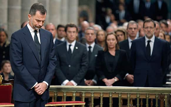 Spain`s Prince Felipe, left stands in front of Spain`s Prime Minister Mariano Rajoy, right during a funeral mass at the cathedral in Santiago de Compostela, Spain.