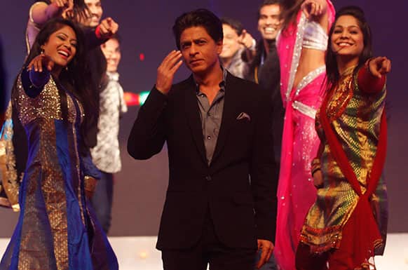 Bollywood star Shah Rukh Khan, center, performs during an event to promote his upcoming movie