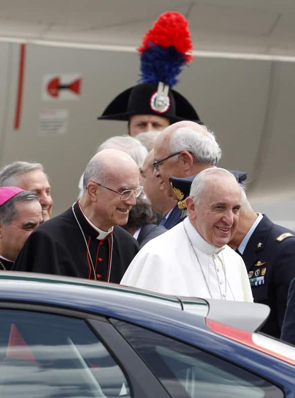 Pope Francis approaches his car after landing from Rio de Janeiro, Brazil, at Ciampino`s military airport, on the outskirts of Rome.