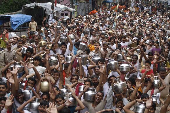 Yadav, an Indian pastoral community, walk carrying water from the River Ganges to offer at the Vishwanath Temple in Varanasi.