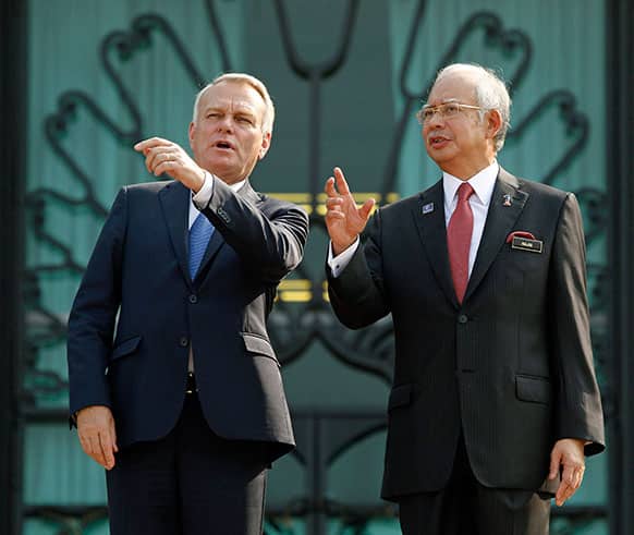 France`s Prime Minister Jean-Marc Ayrault, left, talks with Malaysian Prime Minister Najib Razak during a welcome ceremony in Putrajaya, Malaysia. Ayrault is on a two-day official visit to Malaysia.