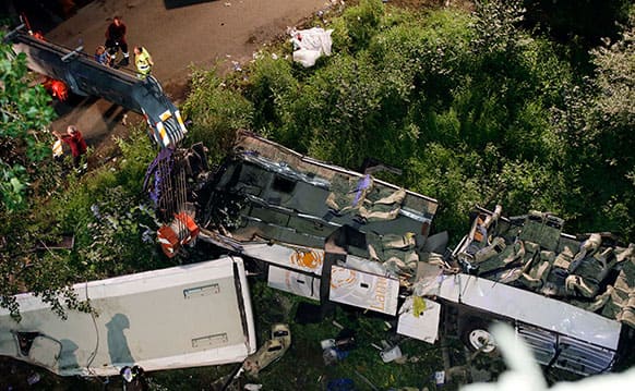 The wreckage of a bus lies on its side following a crash near Avellino, southern Italy. A tour bus filled with Italians returning home after an excursion plunged off a highway into a ravine in southern Italy on Sunday night after it had smashed into several cars that were slowed by heavy traffic, killing at least 37 people.
