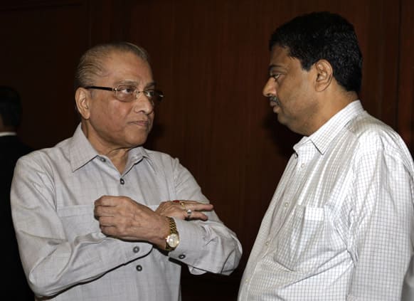 Indian cricket board`s interim president Jagmohan Dalmiya, left, talks with game development officer Ratnakar Shetty, prior to a meeting in Kolkata.
