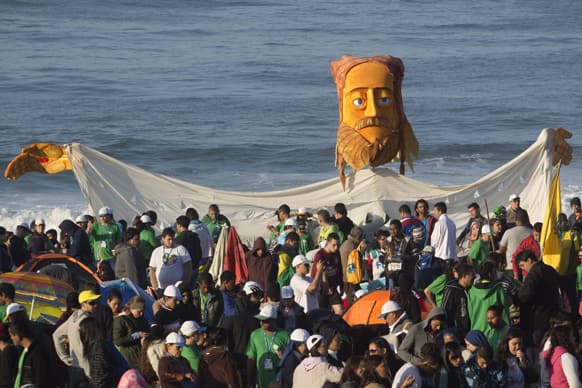 Pilgrims carry a large puppet representing Jesus as they wait for Pope Francis` arrival on Copacabana beach in Rio de Janeiro, Brazil.