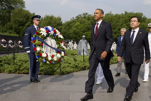 President Barack Obama walks with Special Envoy from the Republic of Korea Kim Jung Hun during a commemorative ceremony at the Korean War Veterans Memorial on the 60th anniversary of the end of the Korean War, on the National Mall in Washington.