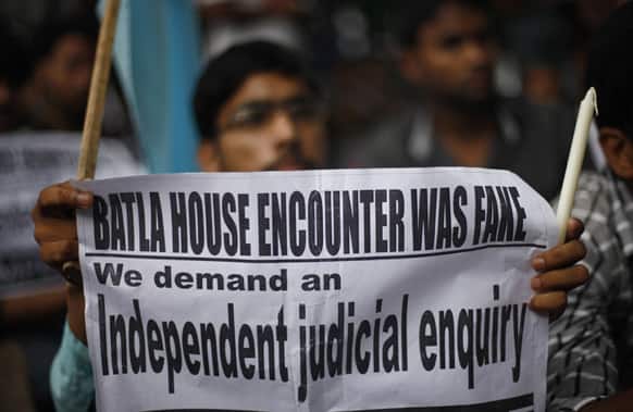 A member of the All India Students Association (AISA) holds a placard as he listens to a speaker, unseen, during a protest march against the recent judgement in Batla House encounter case in New Delhi.