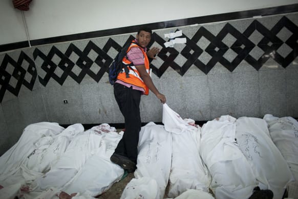 An Egyptian man identifies the body of a supporter of Egypt`s ousted President Mohammed Morsi injured who was killed in clashes with security forces at Nasr City, where pro-Morsi protesters have held a weeks-long sit-in, in a field hospital in Cairo, Egypt.