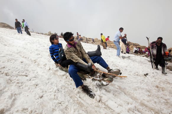 Tourists enjoy sledge ride in snow in Afarwat, Gulmarg, some 60 Kilometers (38 miles) west of Srinagar.