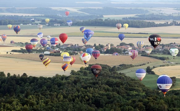 Hot air-balloons fly during the International Lorraine Mondial Air Balloons Festival, in Chambley-Bussieres, eastern France.