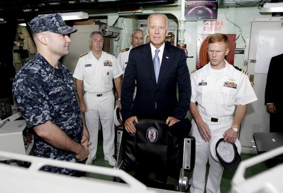 US Vice President Joe Biden, is shown the bridge by Cmdr. Tim Wilke commanding officer of the USS Freedom, the US Navy`s first littoral combat ship on rotational deployment at Changi Naval Base, during his tour to the vessel at the base in Singapore.