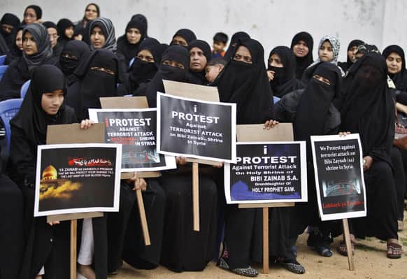 Indian Shiite Muslim women hold placards as they protest during a rally organized to condemn an attack on a Shiite shrine in Syria, in Bangalore.