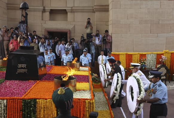 Indian army chief Gen. Bikram Singh, Indian navy chief Adm. Devendra Kumar Joshi and Indian airforce chief Air Chief Marshal NAK Browne, right, pay tribute at India Gate war memorial on the 14th anniversary of India`s victory in the Kargil War in New Delhi.