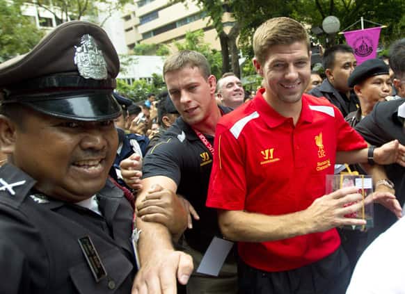 Liverpool`s Steven Gerrard leaves after a visit to pay respects to monarch at Siriraj Hospital in Bangkok, Thailand. The English Premier League team is in Bangkok to play against the Thai national team on July 28.