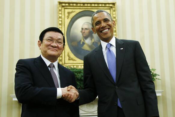 President Barack Obama shakes hands with Vietnam`s President Truong Tan Sang during their meeting in the Oval Office at the White House in Washington.