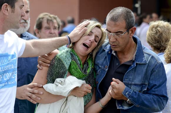 Relatives of victims involved in a train accident react at a victims information point in Santiago de Compostela, Spain.