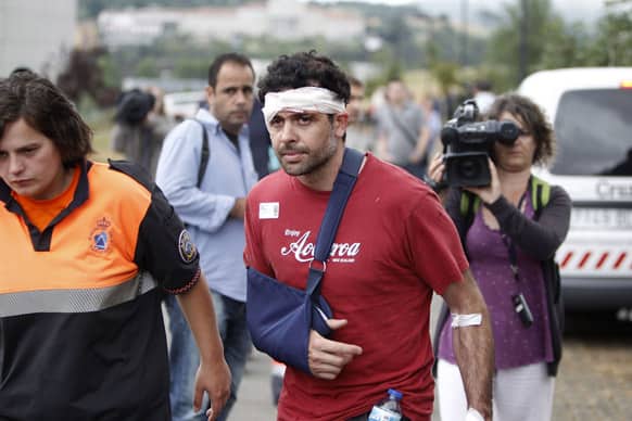 A wounded man involved in a train accident arrives at a victims information point in Santiago de Compostela, Spain.