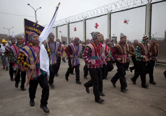 Inmates march dressed with traditional Andean clothing during their own Peruvian Independence Day parade at Lurigancho`s Prison outside of Lima, Peru.