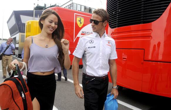British Formula One driver Jenson Button of McLaren Mercedes, right, and his girlfriend Jessica Michibata arrive in the paddock on the Hungaroring circuit near Budapest, Hungary.
